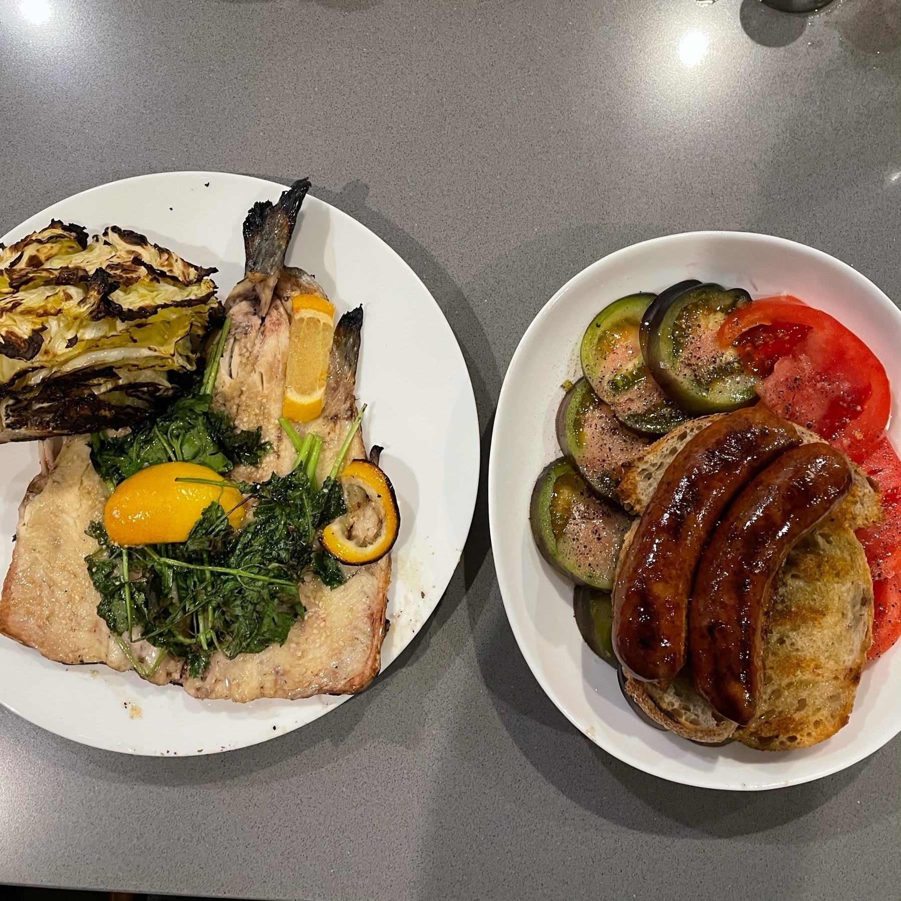 Rainbow trout, charred cabbage, tomato salad, charred sourdough, and chorizo sausage.