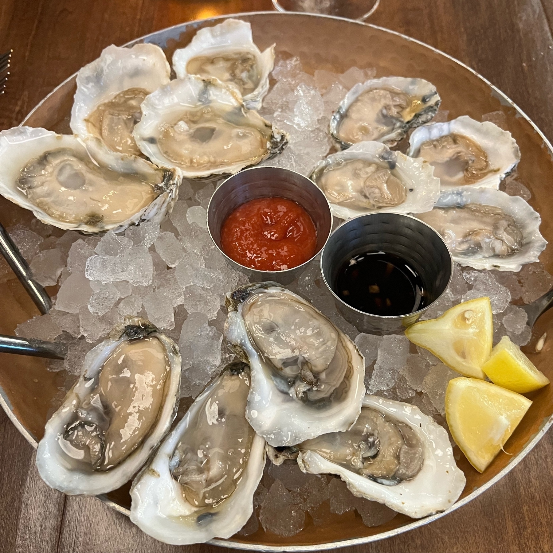 A dozen raw oysters on ice.
