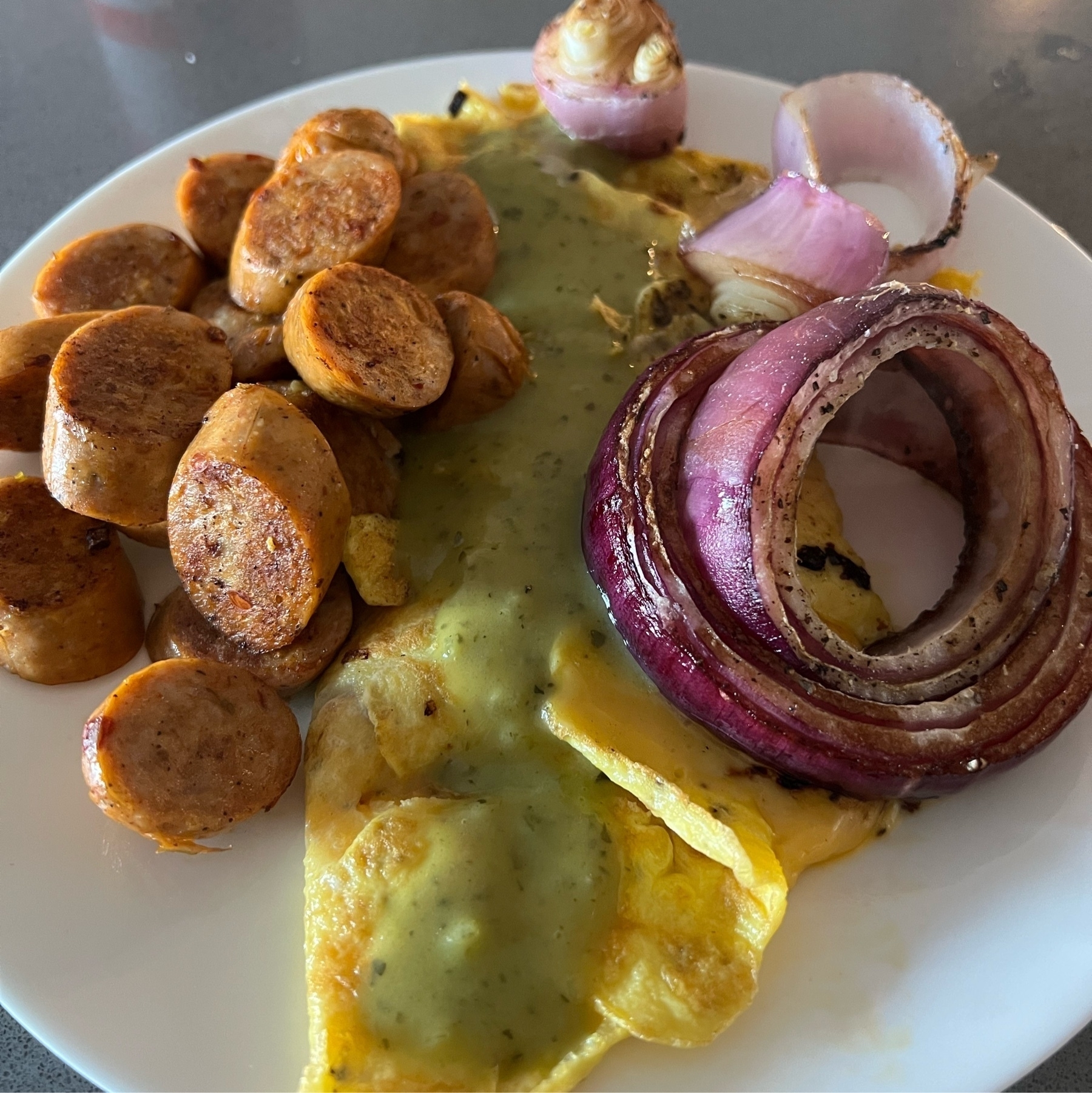 Chicken sausage, roasted red onion, thin omlette, and avocado salsa.