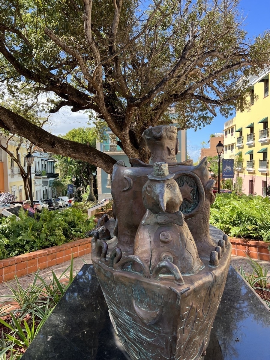 Statue of a peguin in front of trees in square in Viejo San Juan.