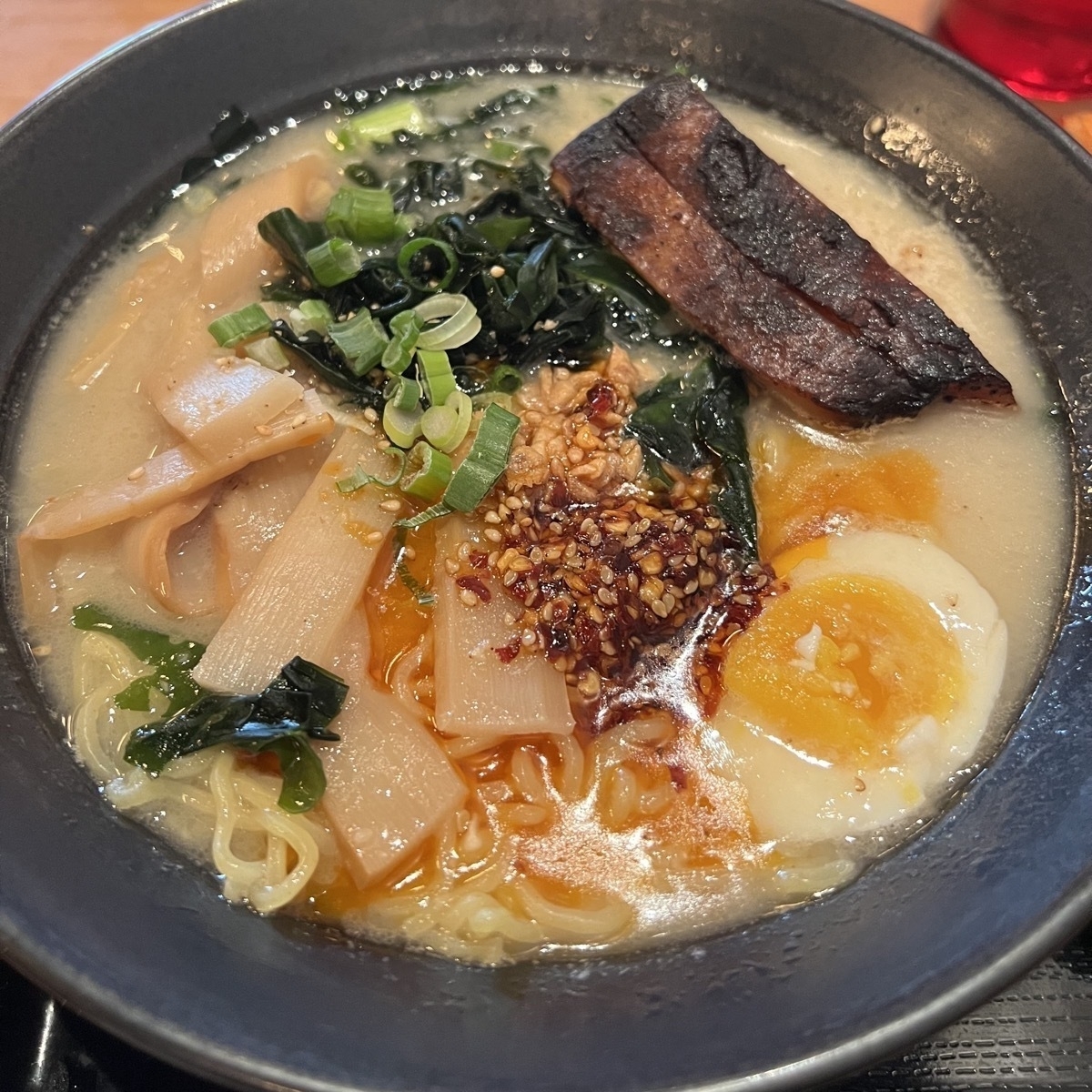 ramen with chili seasame oil, soft boiled egg, and pork